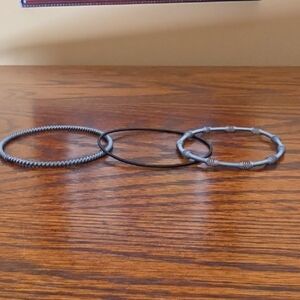 Set of Three Piano wire bangal bracelets.